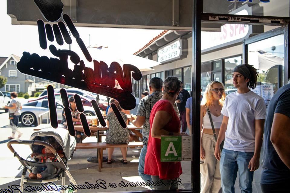 A steady line of hungry customers trails out the door.