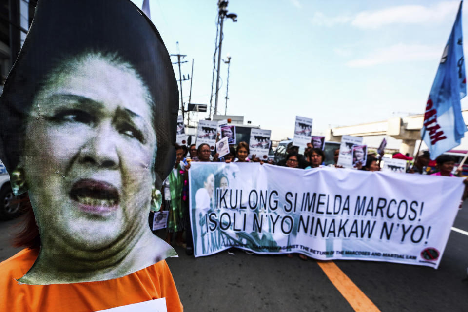 CORRECTS DATE - Protesters display a banner as they picket the anti-graft court Sandiganbayan as former Philippine First Lady Imelda Marcos was ordered to appear to explain her side for not attending last week's promulgation of the graft charges against her Friday, Nov. 16, 2018 in suburban Quezon city northeast of Manila, Philippines. A Philippine court found Imelda Marcos guilty of graft and ordered her arrest last week in a rare conviction among many corruption cases that she's likely to appeal to avoid jail and losing her seat in Congress. The banner reads: Jail Imelda Marcos! Return The Ill-gotten Wealth.! (AP Photo/Maria S. Tan)