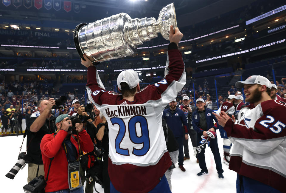 TAMPA, FLORIDA - JUNE 26: Nathan MacKinnon #29 of the Colorado Avalanche hoists the Stanley Cup after the Colorado Avalanche defeated the Tampa Bay Lightning in Game Six of the 2022 Stanley Cup Final at Amalie Arena on June 26, 2022 in Tampa, Florida. The Colorado Avalanche defeated the Tampa Bay Lightning 2-1 in Game Six to take the best of seven Stanley Cup Final series 4 games to 2.  (Photo by Dave Sandford/NHLI via Getty Images)