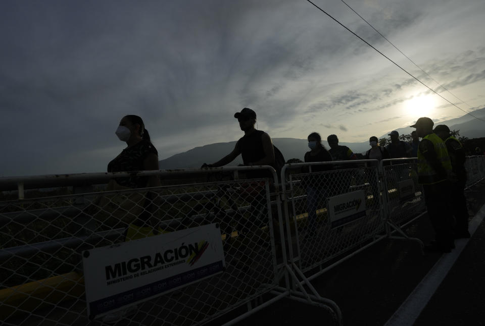 Pedestrians use the Simon Bolivar International Bridge to cross between San Antonio, Venezuela and Cucuta, Colombia, Monday, Sept. 26, 2022. Vehicles with merchandise will cross the bridge on Monday in a ceremonial act to seal the resumption of commercial relations between the two nations. (AP Photo/Fernando Vergara)