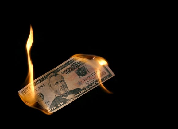 A $50 bill on fire.