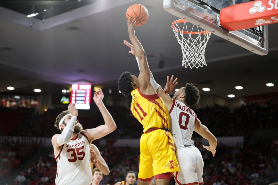 Jan 8, 2022; Norman, Oklahoma, USA; Iowa State Cyclones guard Tyrese Hunter (11) goes up for a basket as Oklahoma Sooners guard Jordan Goldwire (0) defends during the first half at Lloyd Noble Center. Mandatory Credit: Alonzo Adams-USA TODAY Sports