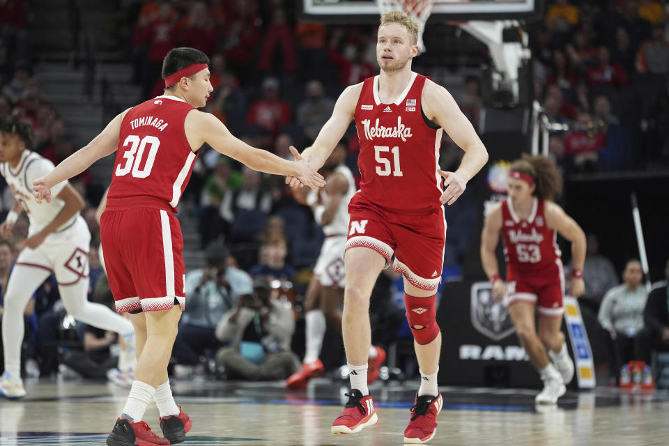 Nebraska forward Rienk Mast (51) slaps hands with guard Keisei Tominaga (30) after making a 3-point shot during the first half of an NCAA college basketball game against Illinois in the semifinal round of the Big Ten Conference tournament, Saturday, March 16, 2024, in Minneapolis. (AP Photo/Abbie Parr)