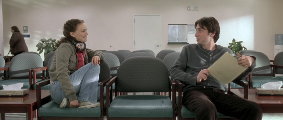 two people sitting and talking in a waiting room