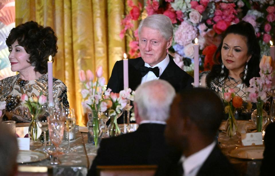 Former US President Bill Clinton attends a State dinner for Japanese Prime Minister Fumio Kishida and his wife Yuko Kishida in the East Room of the White House.