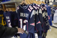 A person browses for Tom Brady jerseys in the pro shop at Gillette Stadium, Monday, Jan. 25, 2021, in Foxborough, Mass. Tom Brady is going to the Super Bowl for the 10th time, and New England Patriots football fans are cheering for him -- just like before. (AP Photo/Elise Amendola)