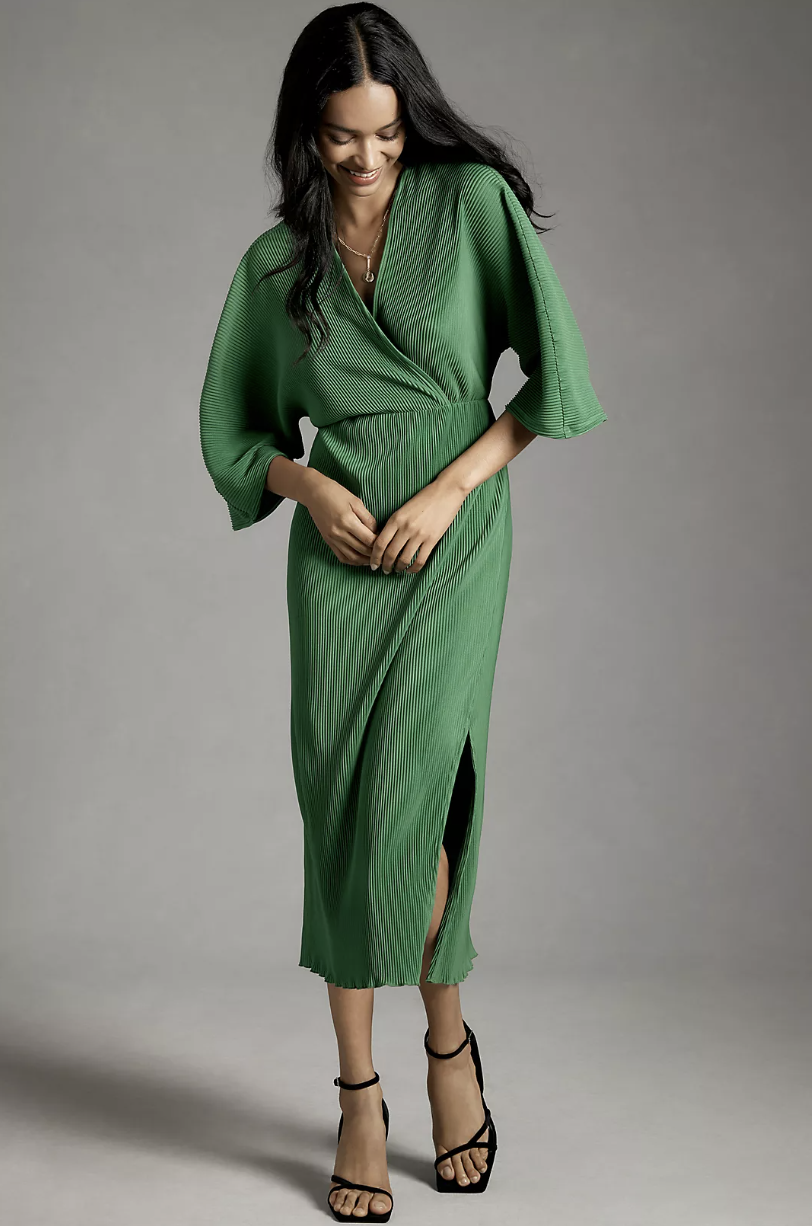 model wearing black sandal heels and green By Anthropologie Plisse V-Neck Wrap Midi Dress (photo via Anthropologie)