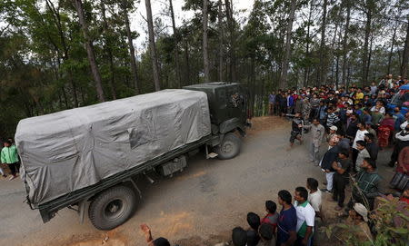 People force an army truck carrying relief supplies off the road, saying they have not received any government food aid five days after Saturday's earthquake, near Chautara, Nepal, April 29, 2015. REUTERS/Olivia Harris