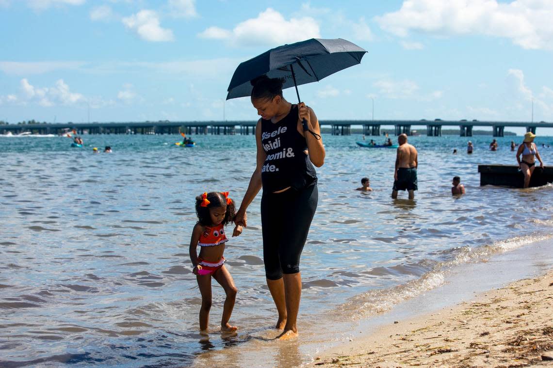 Chimene Purdy walks with her daughter, Naomi Jackson, 5, at Virginia Key Beach Park in 2020.