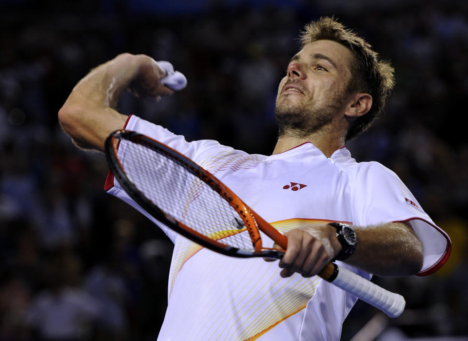 Stanislas Wawrinka of Switzerland throws his wristband to the spectators after defeating Tomas Berdych of the Czech Republic during their semifinal at the Australian Open tennis championship in Melbourne, Australia, Thursday, Jan. 23, 2014.(AP Photo/Andrew Brownbill)