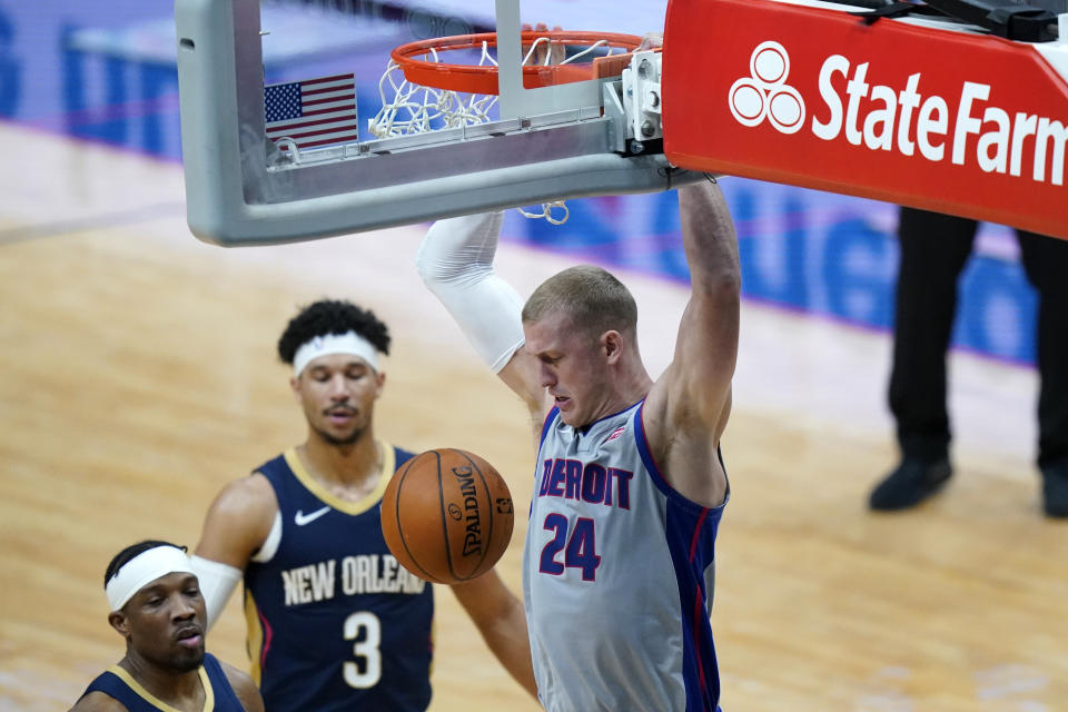 Detroit Pistons center Mason Plumlee (24) dunks next to New Orleans Pelicans guards Eric Bledsoe and Josh Hart (3) during the first half of an NBA basketball game in New Orleans, Wednesday, Feb. 24, 2021. (AP Photo/Gerald Herbert)