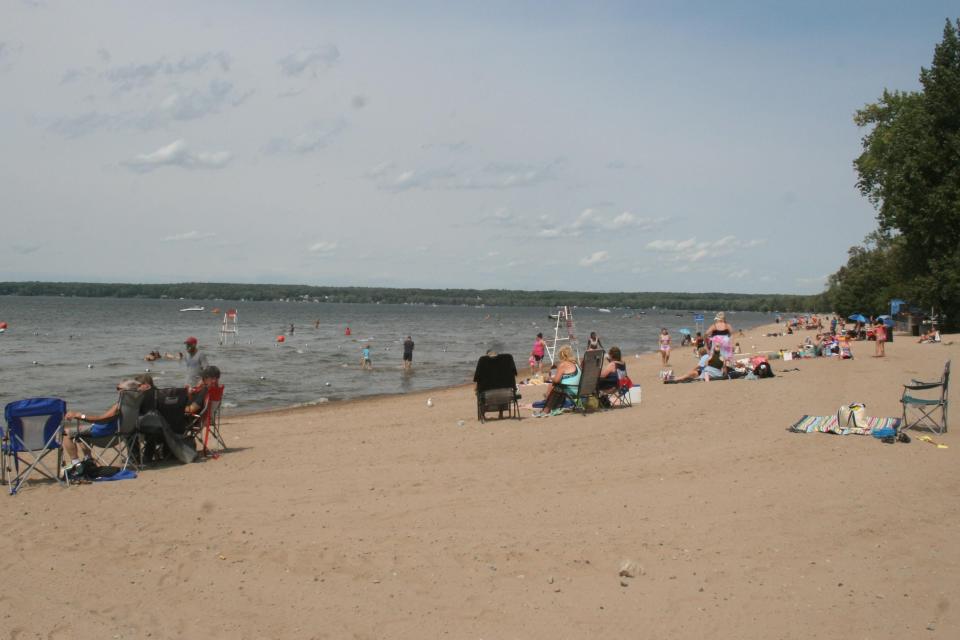 Visitors sit at the edge of Oneida Lake in Sylvan Beach on Sept. 7, 2020.