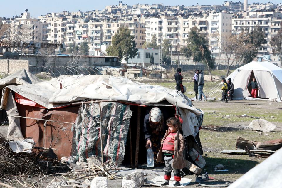 Syrians, displaced as a result of the earthquakes that hit Turkey and Syria on Feb. 6, 2023, are seen in a makeshift camp in the Bustan al-Basha neighborhood in the government-held northern city of Aleppo, Syria, February 20, 2023. / Credit: LOUAI BESHARA/AFP/Getty