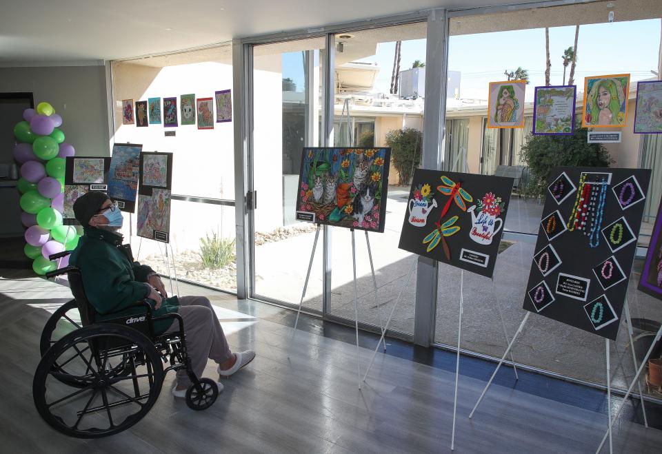 Matthew Sherman checks out some of the artwork on display at the California Nursing and Rehabilitation Center's art showcase in Palm Springs, Calif., Feb. 22, 2023.