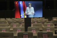 German Chancellor Angela Merkel, displayed on a screen, talks during an online press conference with European Commission President Ursula von der Leyen and European Council President Charles Michel following an EU-China virtual summit at the European Council building in Brussels, Monday, Sept. 14, 2020. Michel, Merkel and Von der Leyen had talks in a videoconference with China's President Xi Jinping. (Yves Herman/Pool Photo via AP)