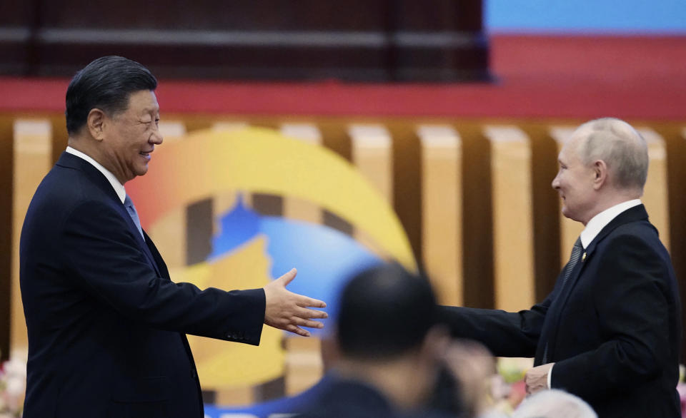 Chinese President Xi Jinping, left, shakes hands with Russian President Vladimir Putin after Xi delivered his opening speech for the Belt and Road Forum at the Great Hall of the People in Beijing, Wednesday, Oct. 18, 2023. (Ken Ishii/Kyodo News via AP)