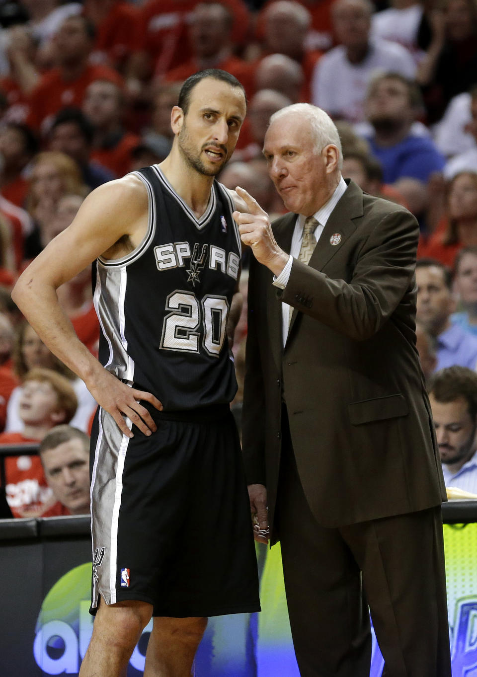 San Antonio Spurs head coach Gregg Popovich talks with San Antonio Spurs' Manu Ginobili (20) in the second half during Game 3 of a Western Conference semifinal NBA basketball playoff series against the Portland Trail Blazers Saturday, May 10, 2014, in Portland, Ore. (AP Photo/Rick Bowmer)