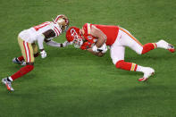 MIAMI, FLORIDA - FEBRUARY 02: Travis Kelce #87 of the Kansas City Chiefs is tackled by Emmanuel Moseley #41 of the San Francisco 49ers during the second quarter in Super Bowl LIV at Hard Rock Stadium on February 02, 2020 in Miami, Florida. (Photo by Elsa/Getty Images)