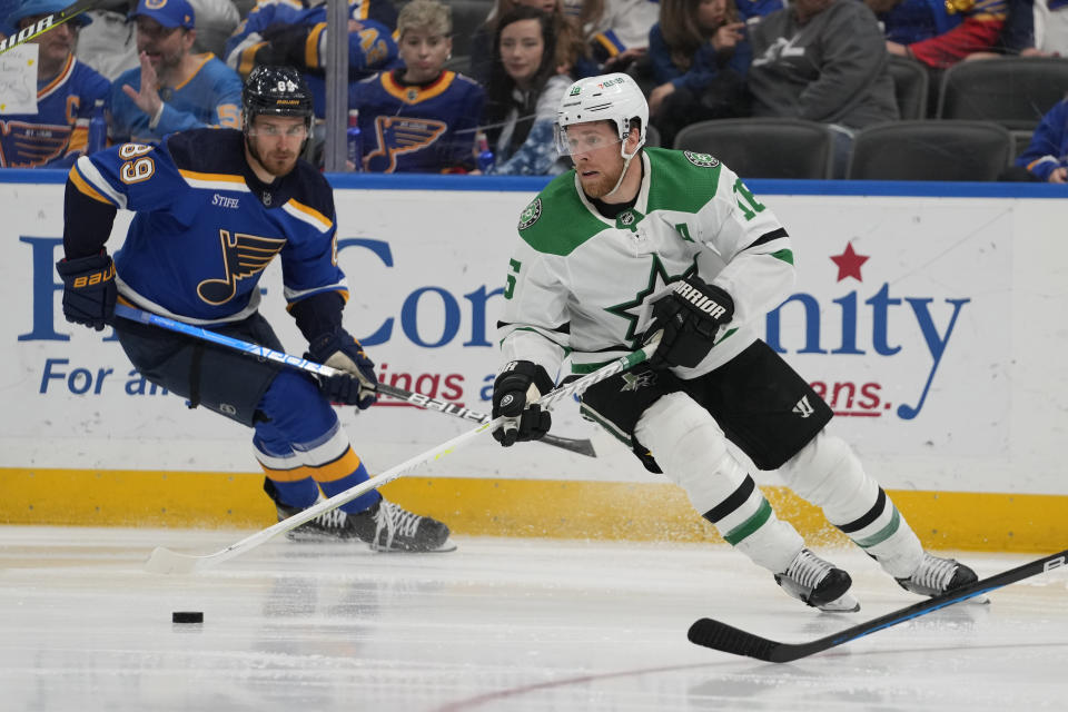 Dallas Stars' Joe Pavelski, right, handles the puck as St. Louis Blues' Pavel Buchnevich (89) defends during the third period of an NHL hockey game Wednesday, April 12, 2023, in St. Louis. (AP Photo/Jeff Roberson)