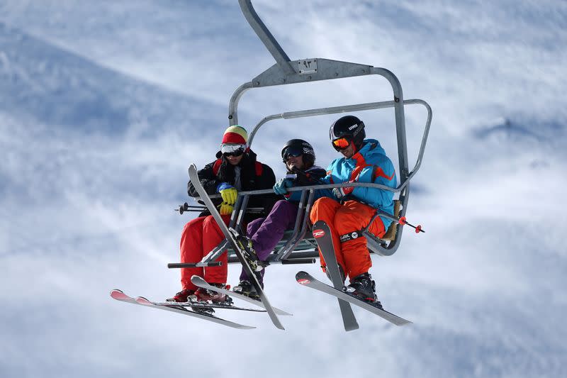 FILE PHOTO: Iranian skiers sit at chairlift at the Tochal ski resort, in north of Tehran