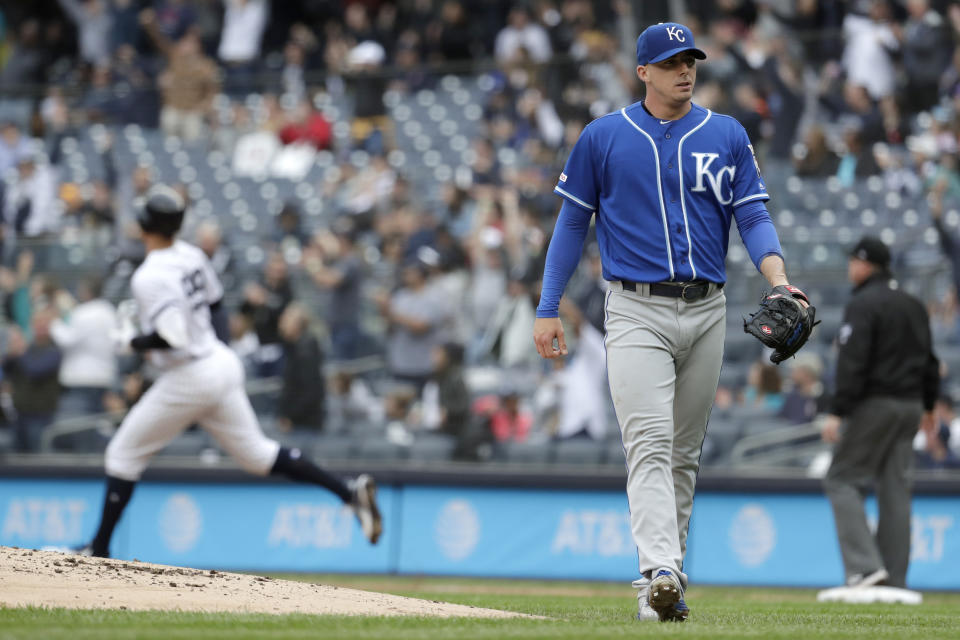 Kansas City Royals relief pitcher Heath Fillmyer, right, looks on as New York Yankees' Aaron Judge, left, runs the bases after hitting a solo home run off him during the first inning of a baseball game, Saturday, April 20, 2019, in New York. (AP Photo/Julio Cortez)