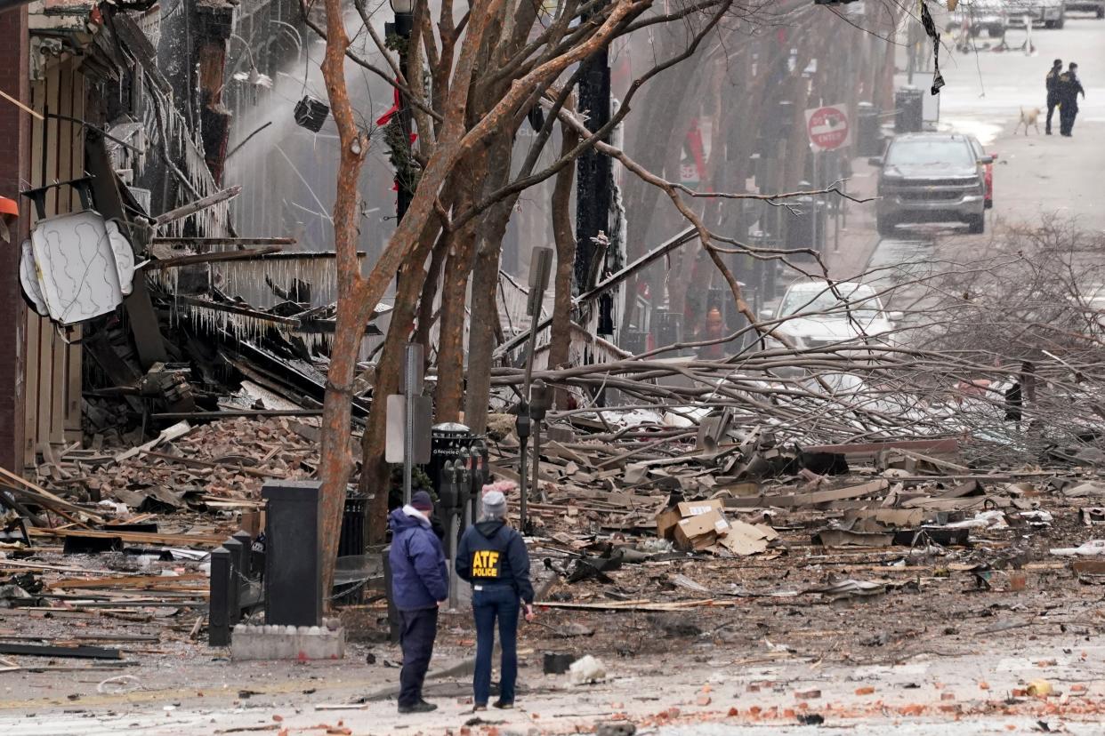 Emergency personnel work near the scene of an explosion in downtown Nashville, Tenn., Friday, Dec. 25, 2020. Buildings shook in the immediate area and beyond after a loud boom was heard early Christmas morning.(AP Photo/Mark Humphrey) (AP)