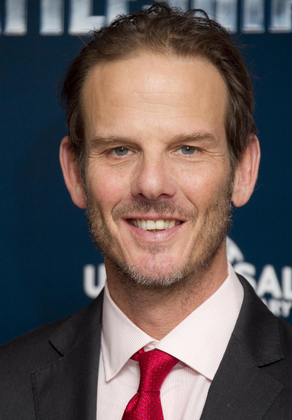 FILE - In this March 28, 2012 file photo, director Peter Berg poses for photographs at a central London hotel for the photo call of "Battleship." Berg, who created TV's “Friday Night Lights,” is accusing Mitt Romney of plagiarizing a phrase from the show to use as a campaign slogan. (AP Photo/Joel Ryan, Fie)