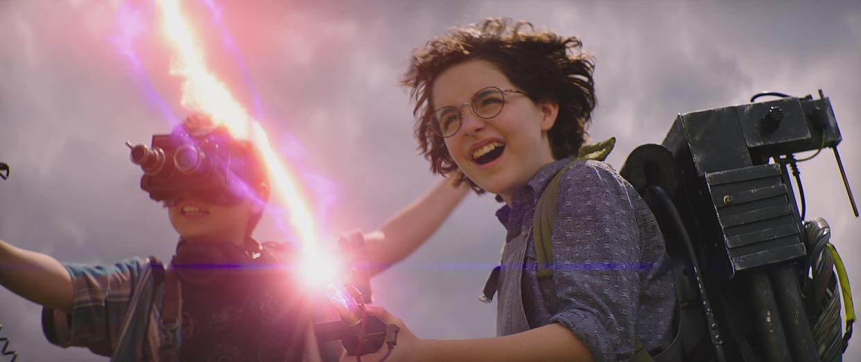 Phoebe (Mckenna Grace) lets loose with her grandpa's proton pack alongside new pal Podcast (Logan Kim) in "Ghostbusters: Afterlife."