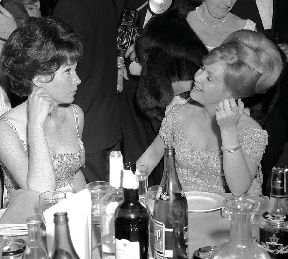 Pals Shirley MacLaine, nominated as best actress for Irma la Douce, and Debbie Reynolds, who presented the best documentary award, chatted it up at the 1964 ball.