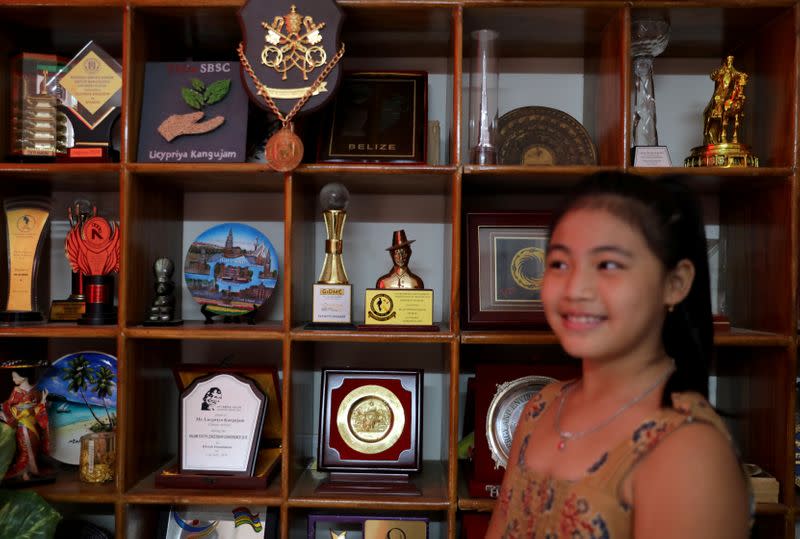 Licypriya Kangujam poses in front of her trophies at her house in Noida