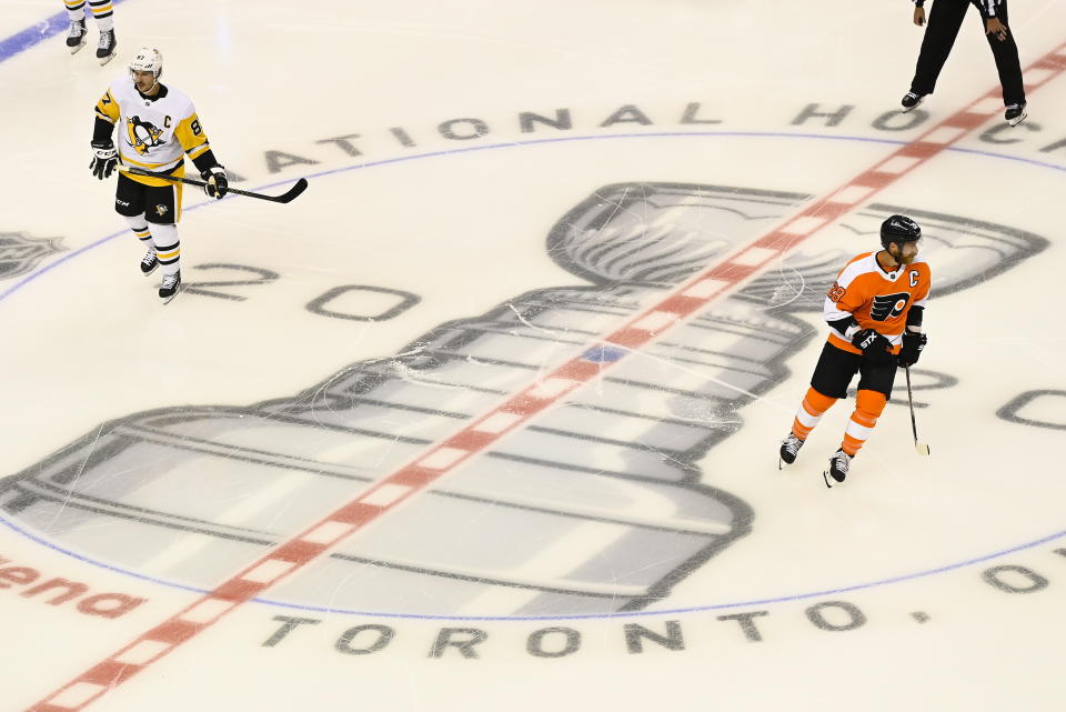 Pittsburgh Penguins center Sidney Crosby (87) and Philadelphia Flyers center Claude Giroux (28) get ready to face-off before an exhibition NHL hockey game, Tuesday, July 28, 2020 in Toronto. (Nathan Denette/The Canadian Press via AP)