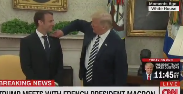Trump wipes 'piece of dandruff' off Macron's lapel in bizarre and awkward White House moment