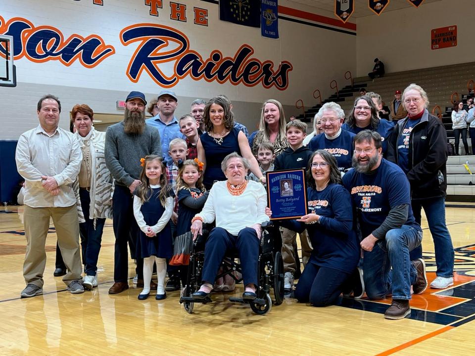Longtime Harrison coach, teacher and Indiana athletics pioneer Betty Bolyard (center) surrounded by family and friends on Saturday, Jan. 21 will have the Harrison track and field course named in her honor.