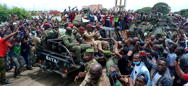 Residents cheer on army soldiers after uprising that led to toppling of president Alpha Conde in Guinea