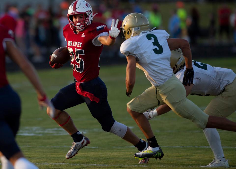 Tecumseh's Chase Jones (25) eludes defender Forest Park's Jaxon Lueken (3) during their game at Tecumseh High School Friday evening, Sept. 9, 2022.