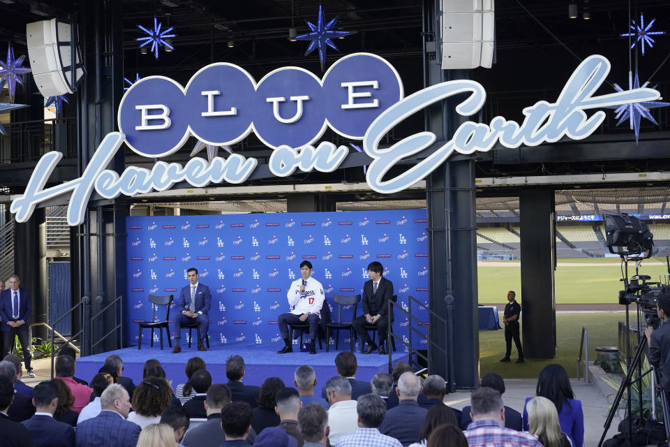 Los Angeles Dodgers' Shohei Ohtani, middle, speaks during a baseball news conference at Dodger Stadium Thursday, Dec. 14, 2023, in Los Angeles. (AP Photo/Marcio Jose Sanchez)