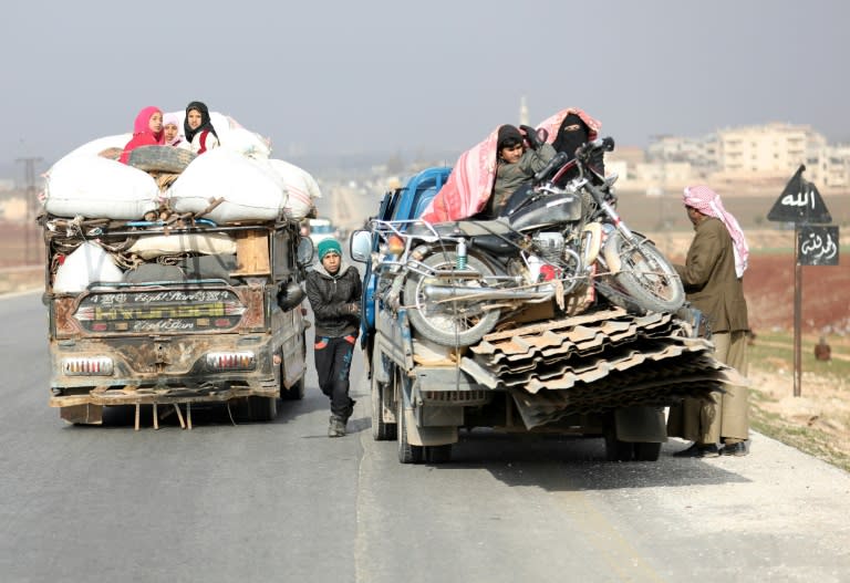 Displaced families from a village in southern Idlib head towards the northern part of the province via the Damascus-Aleppo motorway on December 30, 2017