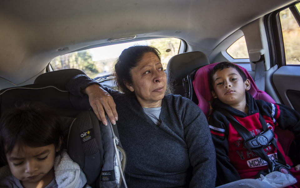 Maria Campos, 52, fights back tears while approaching the Stewart Detention Center with her grandkids to visit her son, Sunday, Nov. 10, 2019, in Lumpkin, Ga. Campos' son was deported a year ago from the same ICE facility where another son is now detained. "My first son, my heart is broken because he's not here. I don't want the same for the second one," said Campos. "This place is a horrible place because not all the lawyers want to go there and fight for our family members." Immigrants being held in the rural detention center face a host of challenges in fighting their cases. The town has few available resources, only three immigration lawyers work there full time. In the vacuum, a small network has sprung up to help the immigrants. (AP Photo/David Goldman)