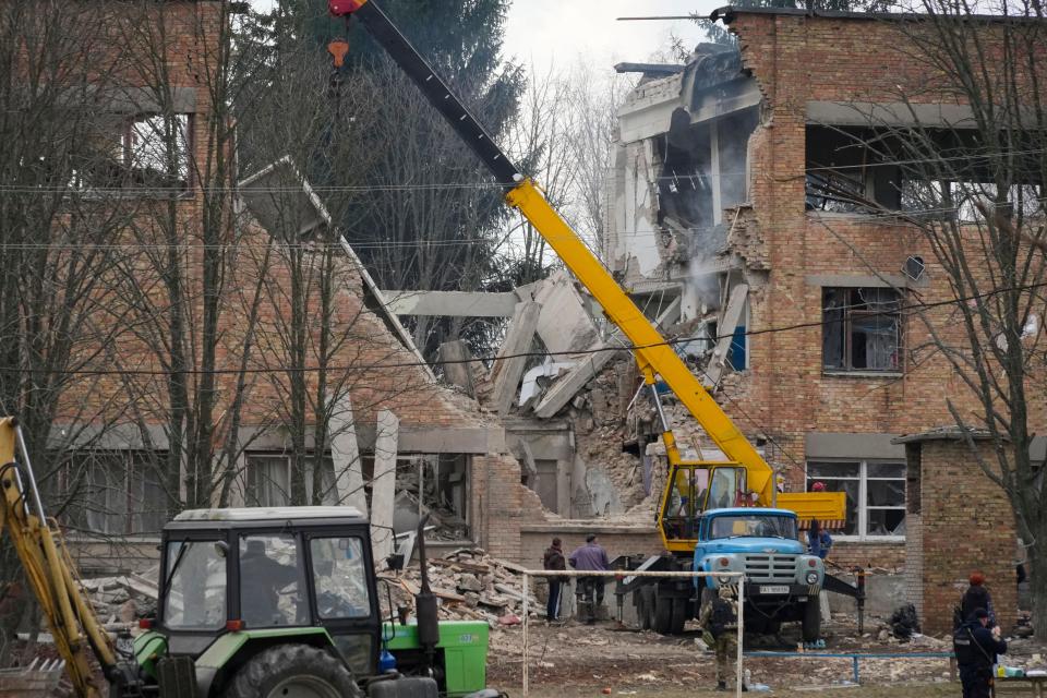 Emergency personnel work at the scene following a drone attack in the town of Rzhyshchiv, Kyiv region, Ukraine, Wednesday, March 22, 2023.