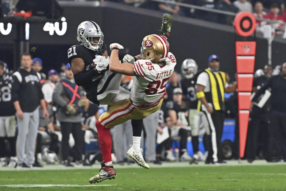 Las Vegas Raiders cornerback Amik Robertson (21) intercepts a pass intended for San Francisco 49ers tight end George Kittle (85) during the second half of an NFL football game between the San Francisco 49ers and Las Vegas Raiders, Sunday, Jan. 1, 2023, in Las Vegas. (AP Photo/David Becker)