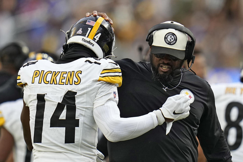 Pittsburgh Steelers wide receiver George Pickens, left, celebrates with head coach Mike Tomlin after running back Jaylen Warren scores a touchdown during the second half of an NFL football game against the Los Angeles Rams Sunday, Oct. 22, 2023, in Inglewood, Calif. (AP Photo/Gregory Bull)