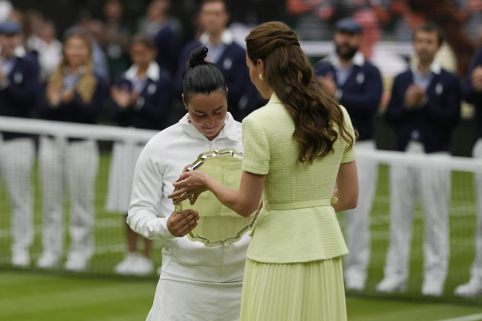 Tunisia's Ons Jabeur receives her runners up trophy from Britain's Kate, Princess of Wales after losing to Czech Republic's Marketa Vondrousova in the women's singles final on day thirteen of the Wimbledon tennis championships in London, Saturday, July 15, 2023. (AP Photo/Alastair Grant)