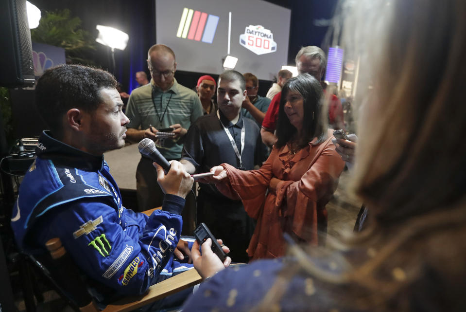 Kyle Larson, left, answers questions from reporters during NASCAR Daytona 500 auto racing media day at Daytona International Speedway, Wednesday, Feb. 12, 2020, in Daytona Beach, Fla. (AP Photo/John Raoux)