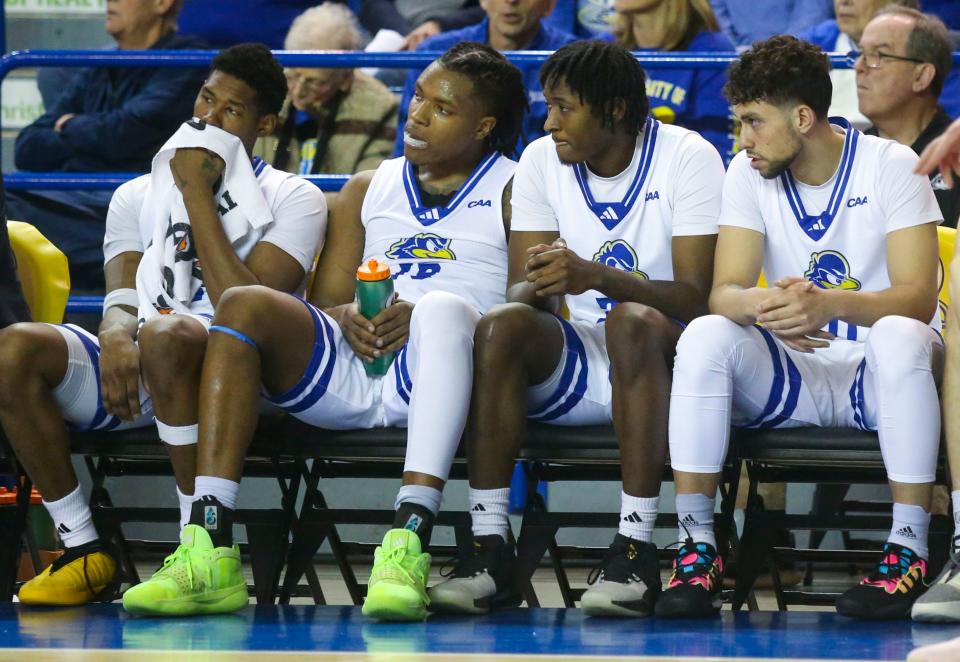 Delaware's (from left) Jalun Trent, Jyare Davis, Wes Peterson and Kobe Jerome watch the final moments of Delaware's 67-56 loss at the Bob Carpenter Center, Saturday, Jan. 27, 2024.