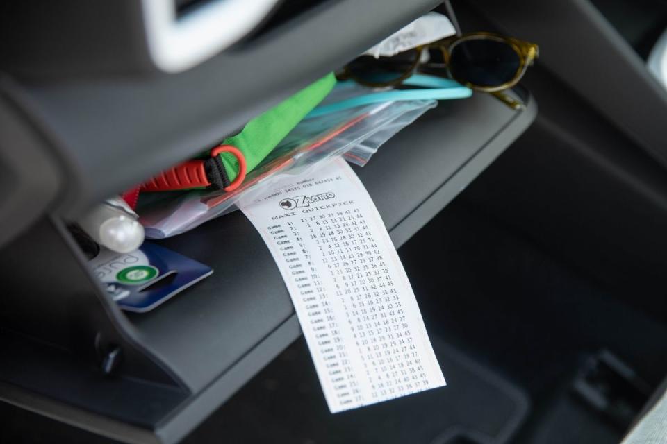 Oz Lotto ticket sits in car glove box