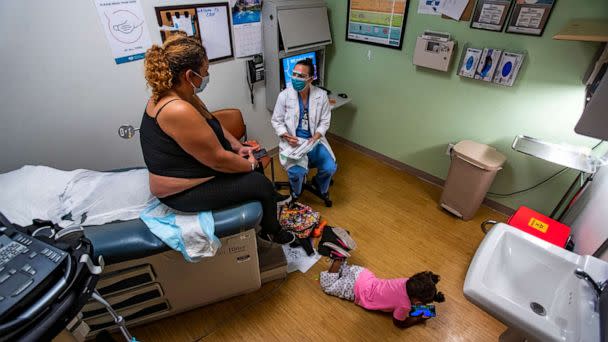 PHOTO: Dr. Lisa Hofler discusses the procedure for getting a medication abortion to patient while the patient's 3-year-old daughter plays on the floor of the Reproductive Center in Albuquerque, N.M., June 21m 2022. (Los Angeles Times via Getty Images, FILE)