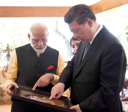 India's Prime Minister Narendra Modi and China's President Xi Jinping exchange gifts in Mamallapuram