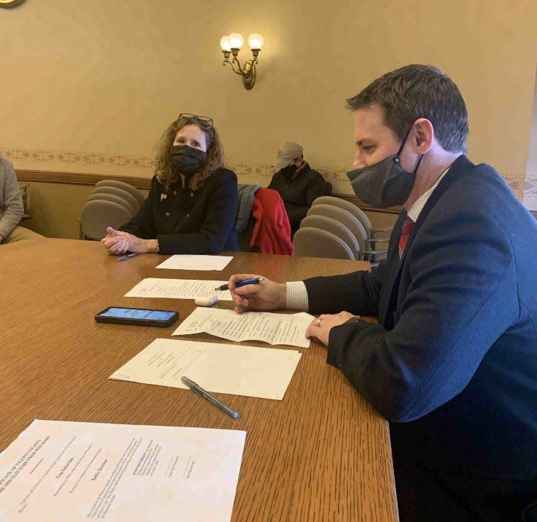Former Republican Party of Wisconsin chairman Andrew Hitt signs paperwork on Dec. 14, 2020 claiming to be an elector for Donald Trump. The meeting took place in the Wisconsin State Capitol.