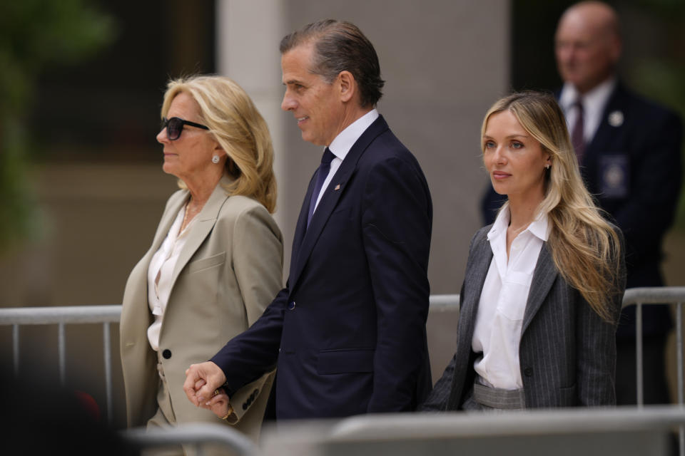 Hunter Biden, center, President Joe Biden's son, accompanied by his mother, first lady Jill Biden, left, and his wife, Melissa Cohen Biden, right, walks out of federal court after hearing the verdict, Tuesday, June 11, 2024, in Wilmington, Del. Hunter Biden has been convicted of all 3 felony charges in the federal gun trial. (AP Photo/Matt Rourke)