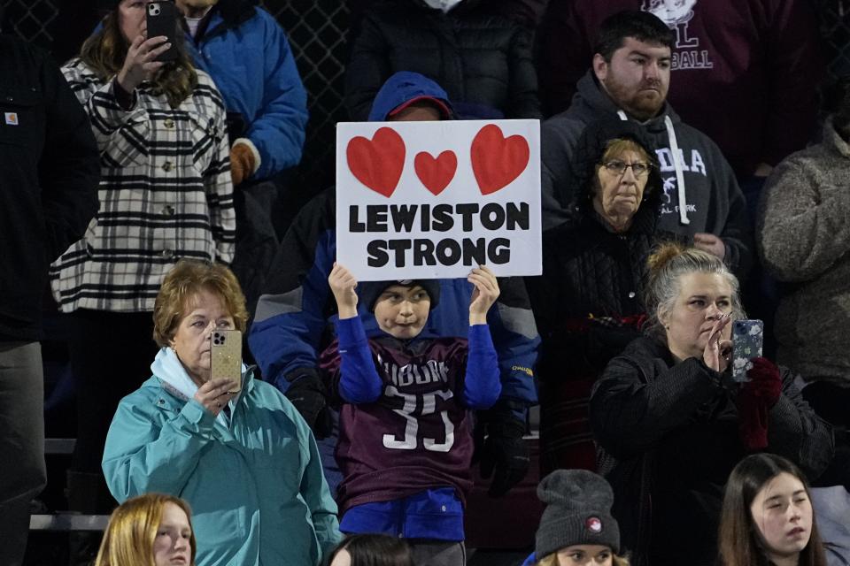 Edward Little High School fans stand during a moment of silence for the victims of the Lewiston shooting, Wednesday, Nov. 1, 2023, prior to a high school football game against Lewiston High School in Lewiston, Maine. Locals seek a return to normalcy after the mass shooting on Oct. 25. (AP Photo/Matt York)